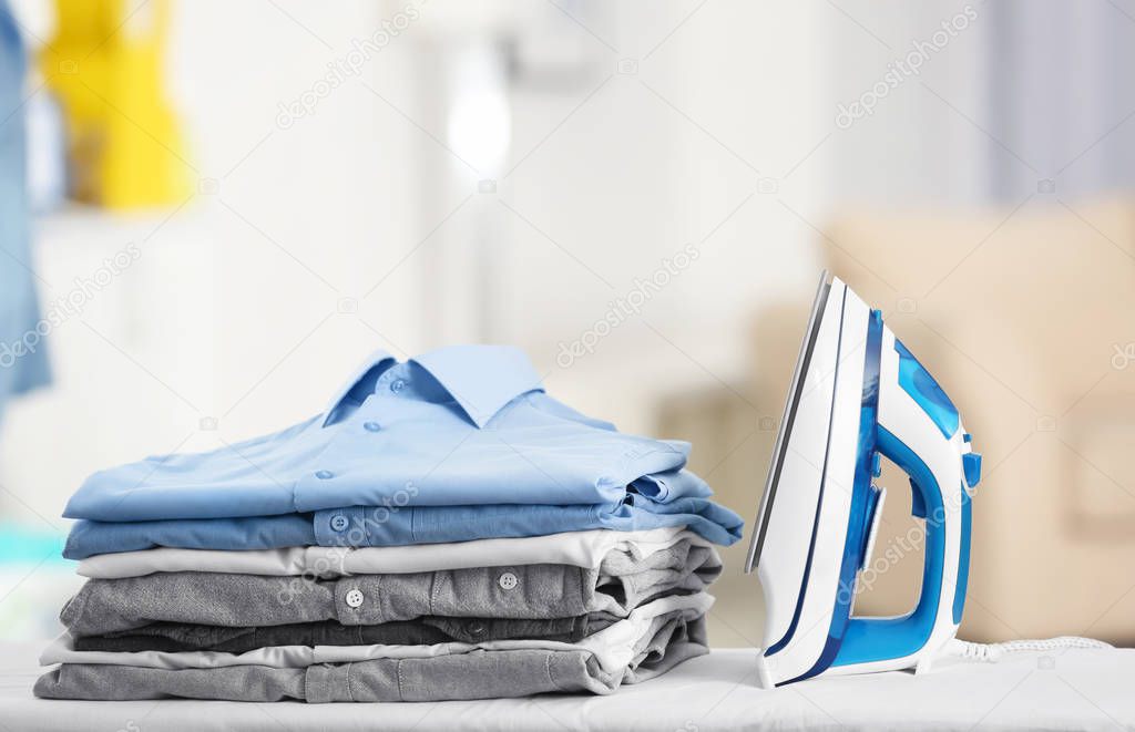 Electric iron and pile of clothes 