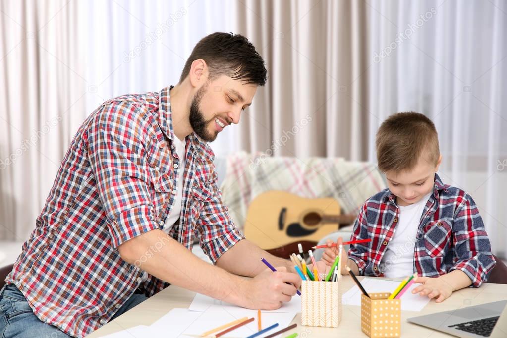 Father and son drawing pictures