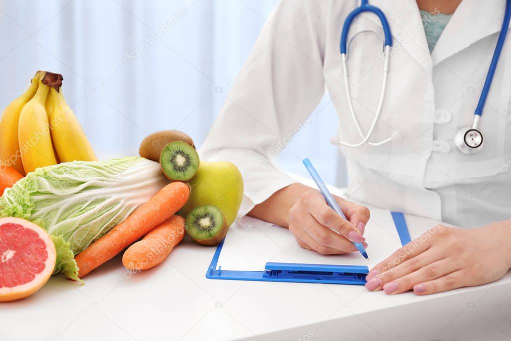 Nutritionist doctor writing diet plan 