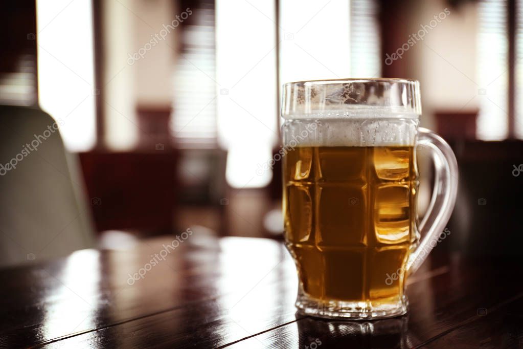 Glass of beer on table