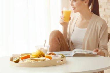 young woman having breakfast  clipart