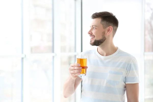 Handsome man posing with juice