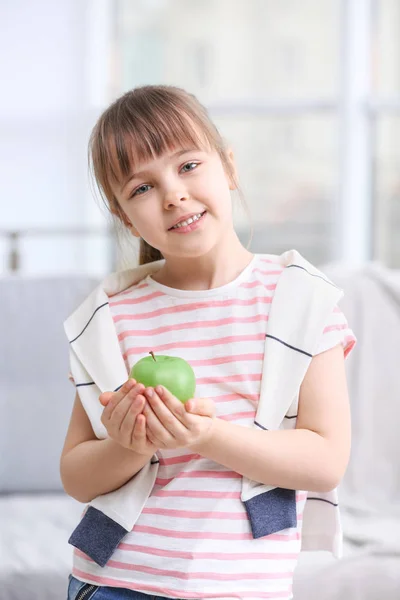 Happy schoolgirl sitting with apple — Stock Photo, Image
