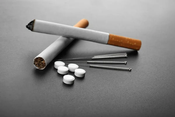 Cigarettes with needles and pills — Stock Photo, Image