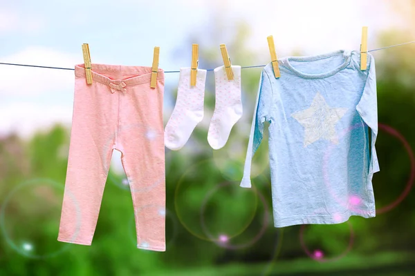 Baby laundry hanging on clothesline — Stock Photo, Image