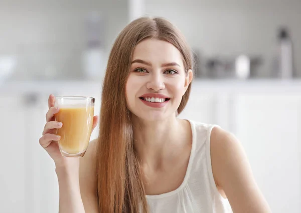 Young woman tasting juice — Stock Photo, Image