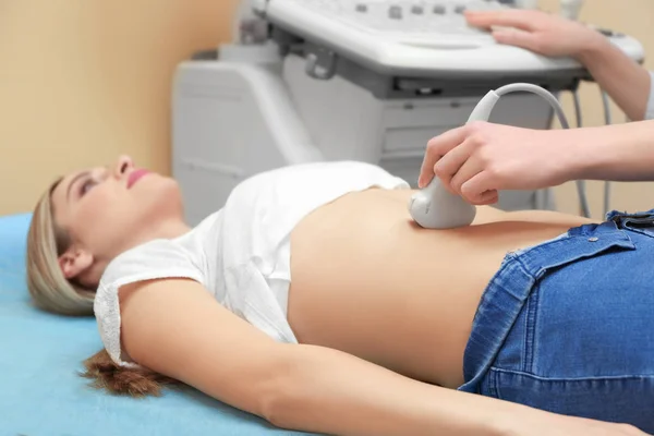 Jonge vrouw ondergaan ultrasone scan in moderne kliniek — Stockfoto