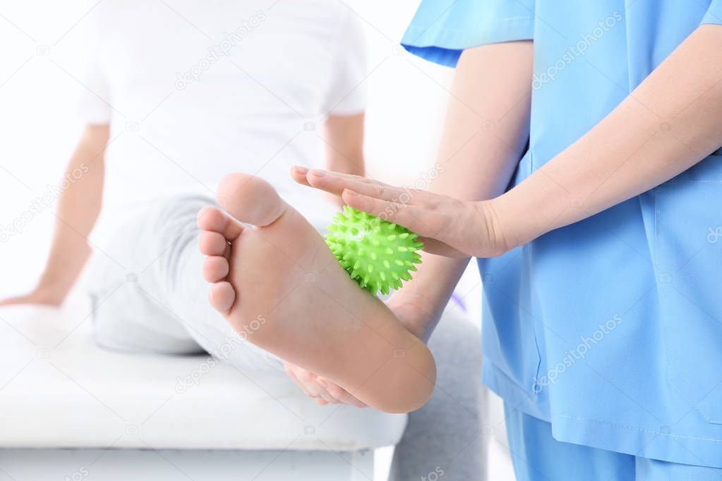 Orthopedist working with patient  