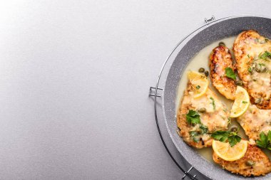 Frying pan with chicken piccata clipart