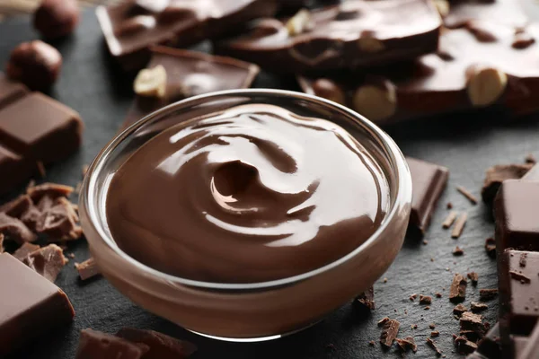 Bowl with melted chocolate a — Stock Photo, Image