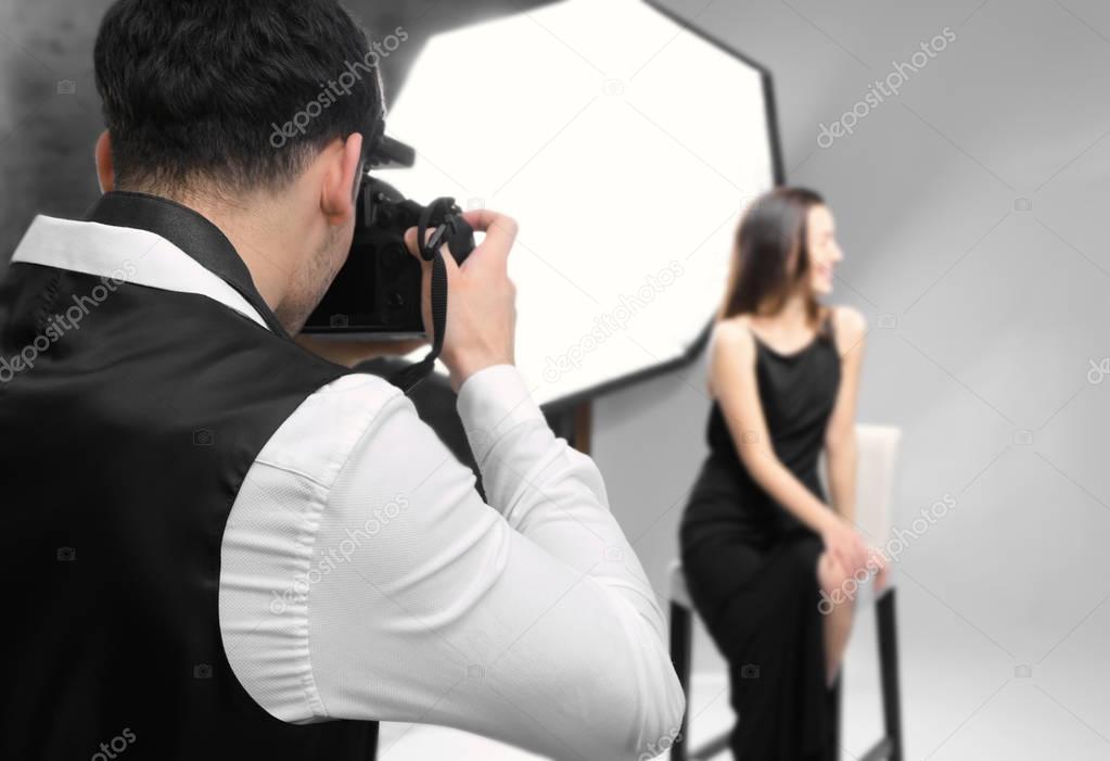 Model posing for professional photographer at studio