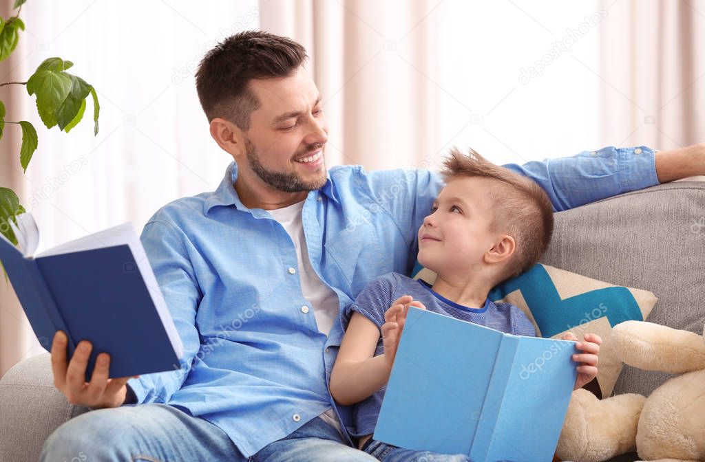 Dad and son reading interesting books  