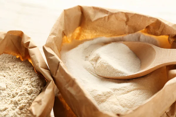 Bag with flour and spoon — Stock Photo, Image