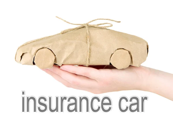 Car insurance concept. Woman holding automobile wrapped in paper on white background — Stock Photo, Image