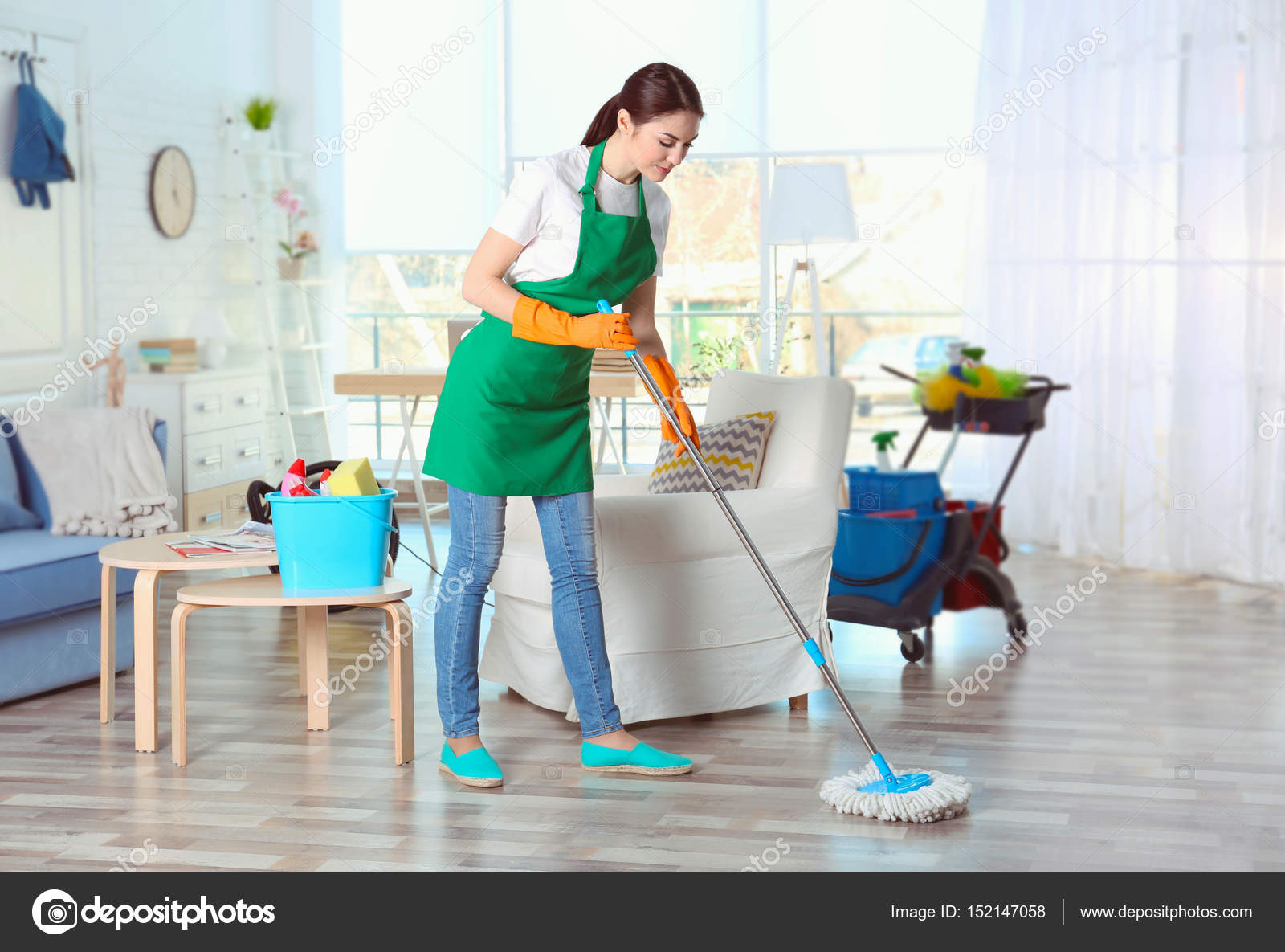 Young female cleaner Stock Photo by ©belchonock 152147058