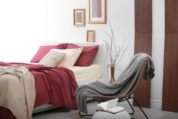 Cómoda cama con ropa de cama de color burdeos —  Fotos de Stock