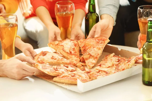 Mãos de amigos tomando fatias de pizza — Fotografia de Stock