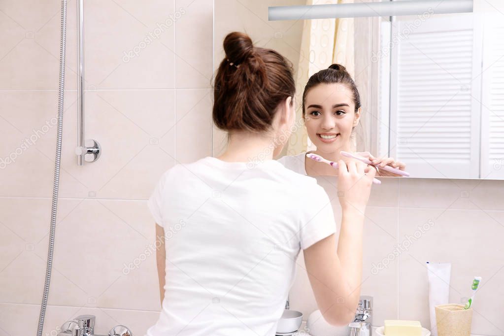 Beautiful woman brushing teeth 