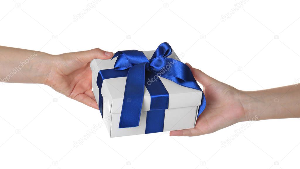Hands giving and receiving gift box