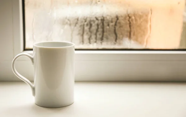 Cup of tea on windowsill — Stock Photo, Image