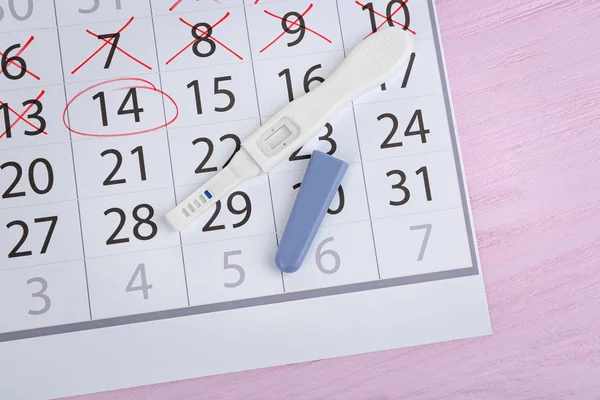 Calendar with pregnancy test — Stock Photo, Image