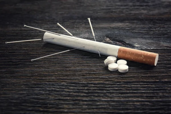 Cigarette with needles and pills — Stock Photo, Image