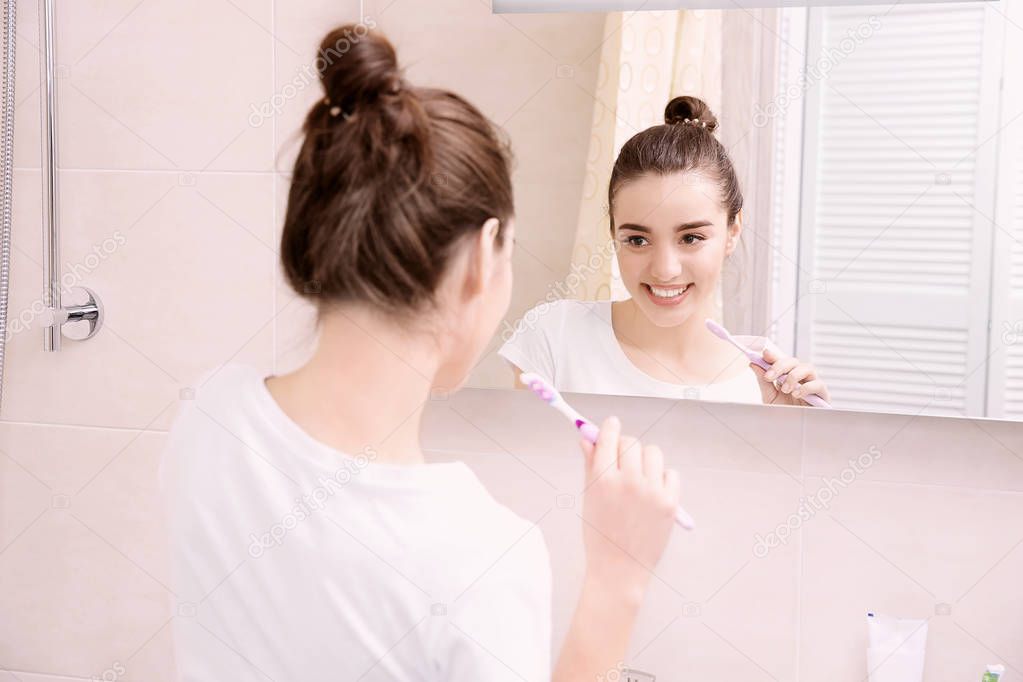 Beautiful woman brushing teeth 