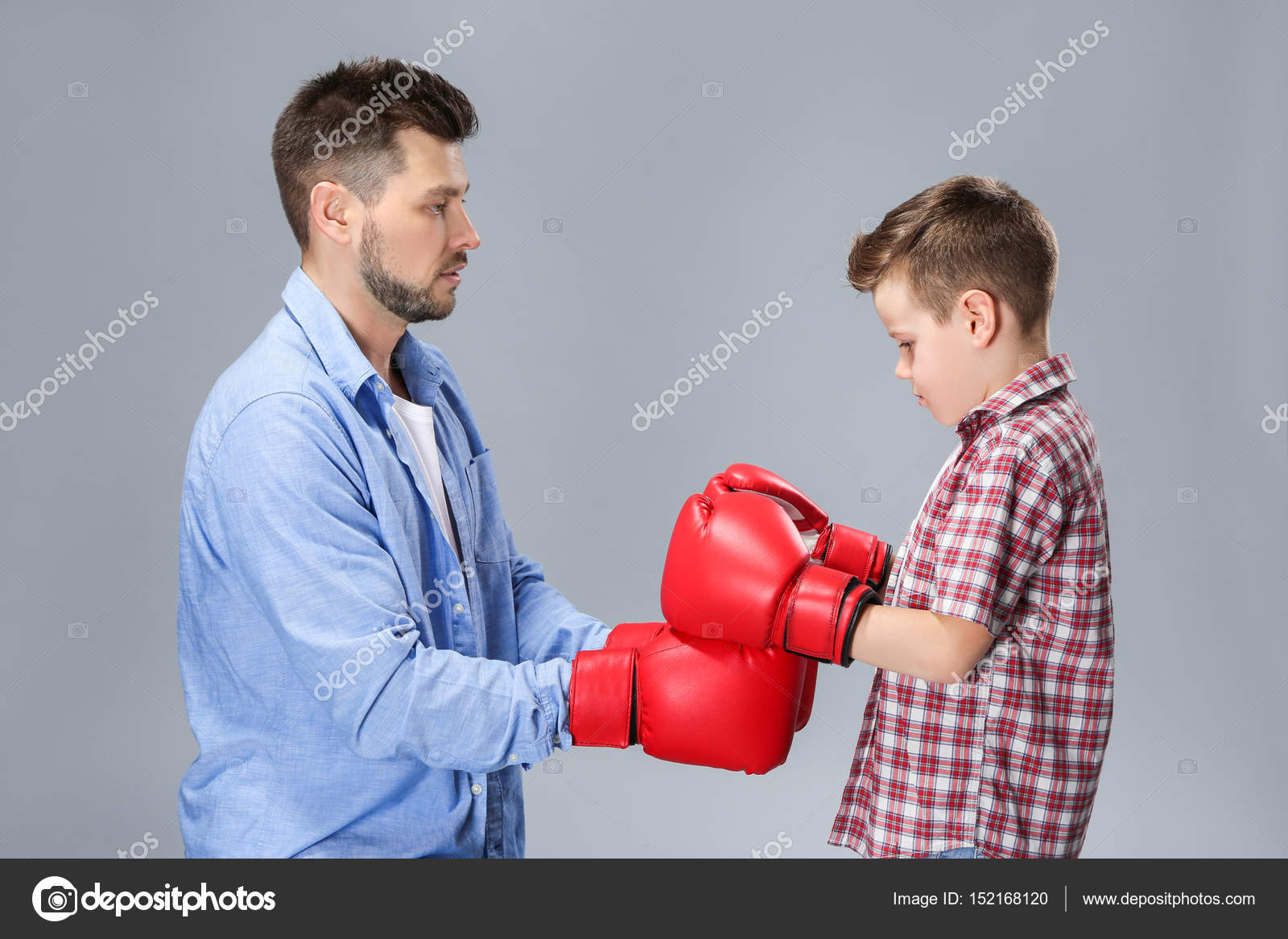 Father and son having boxing training — Stock Photo © belchonock 152168120