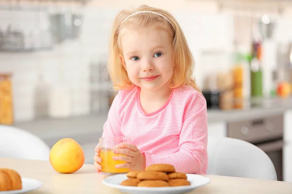 Cute little girl having breakfast at home — Stock Photo, Image