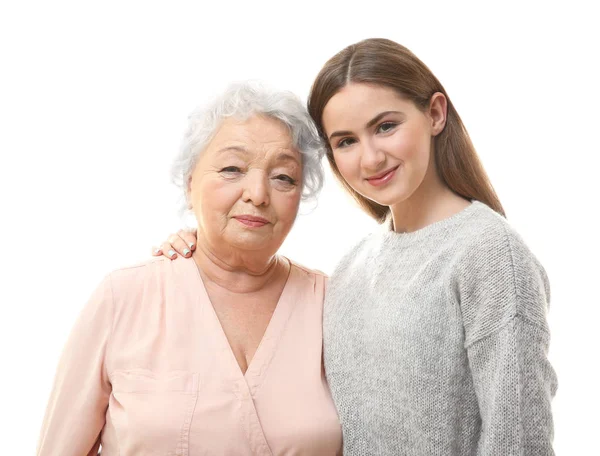 Schönes Mädchen mit Großmutter auf weißem Hintergrund — Stockfoto
