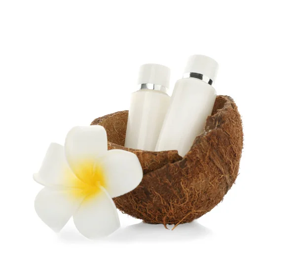 Bottles with cream in coconut rind and tropical flower — Stock Photo, Image