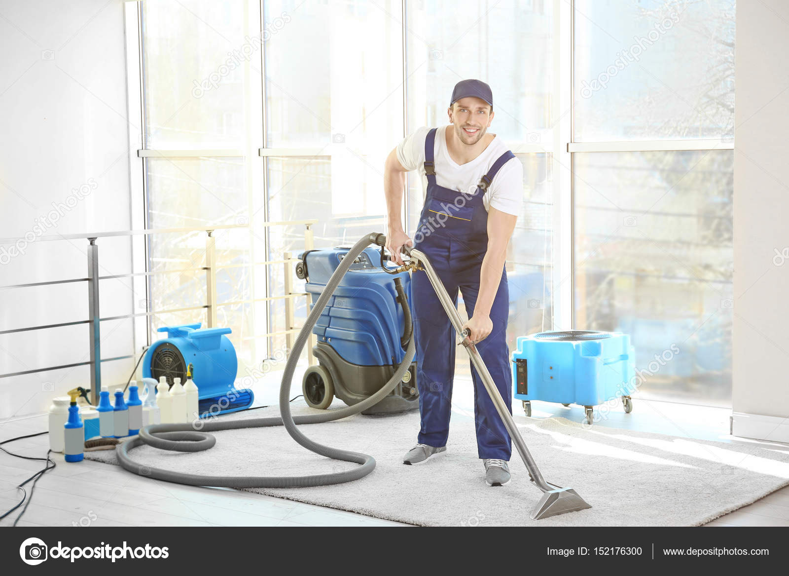 Dry cleaners employee removing dirt Stock Photo by ©belchonock 152176300