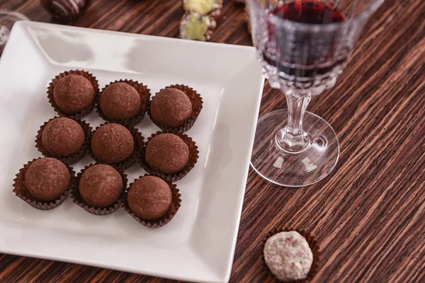 Chocolate candies and glass of wine