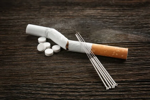 Cigarette with needles and pills — Stock Photo, Image