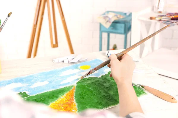 Hand of painter creating colorful landscape — Stock Photo, Image