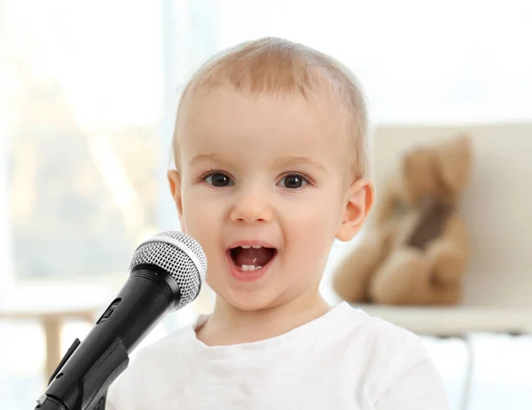 Cute baby z mikrofonem w domu — Zdjęcie stockowe