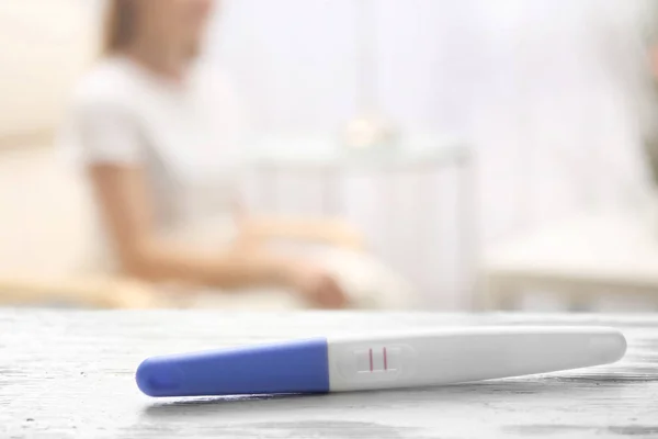 Pregnancy test and blurred woman — Stock Photo, Image