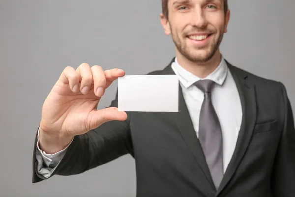 Handsome young man with business card — Stock Photo, Image