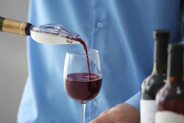 Sommelier pouring red wine — Stock Photo, Image