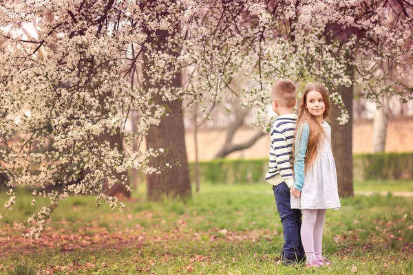 Niña y niño en el parque de primavera — Foto de Stock