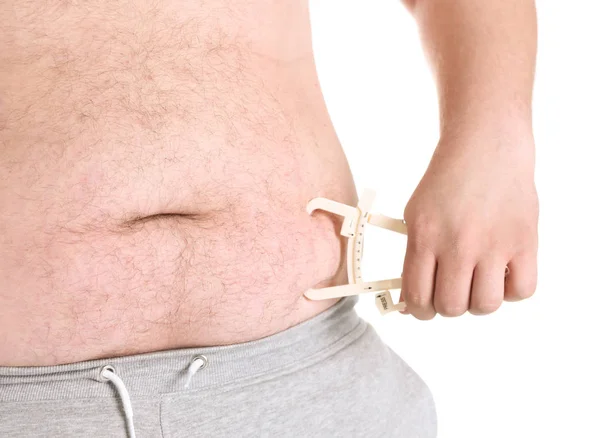 Hombre gordo con pinza de medición — Foto de Stock