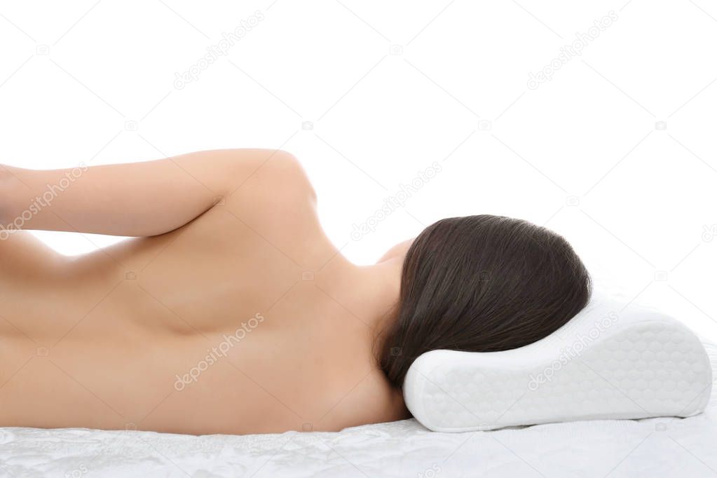 woman lying on bed with orthopedic pillow