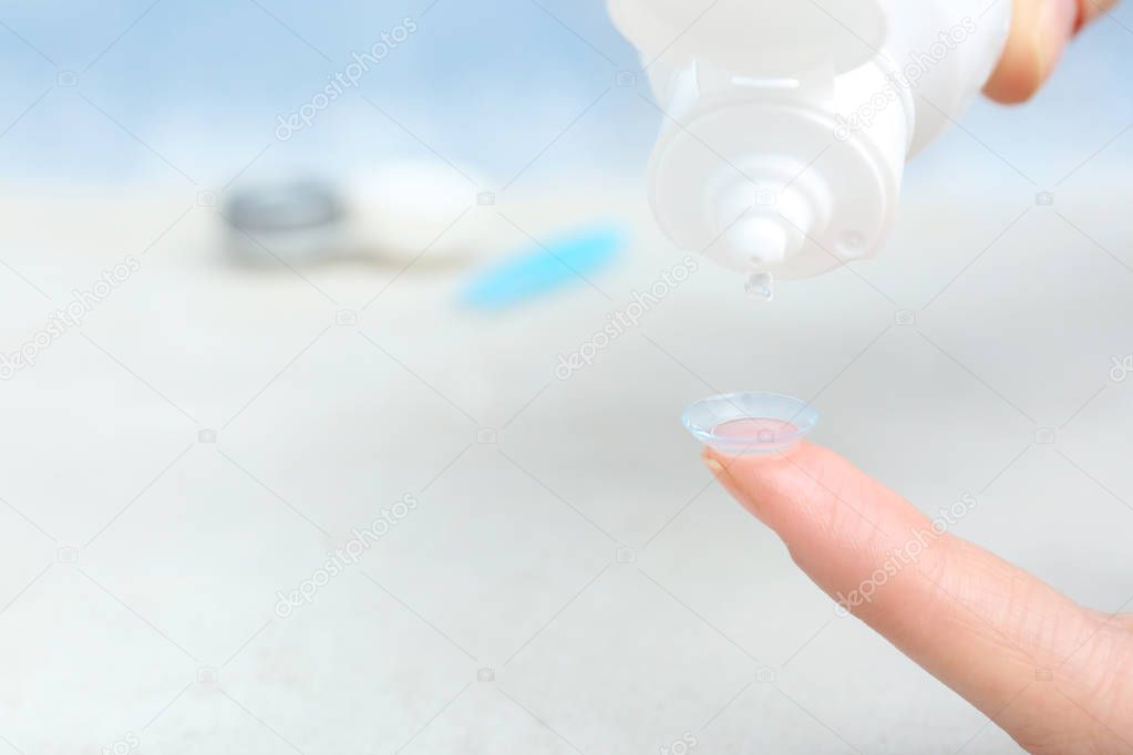 Contact lens on female finger 