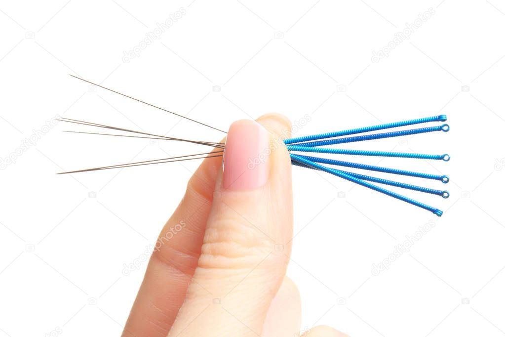 Female fingers with needles for acupuncture 