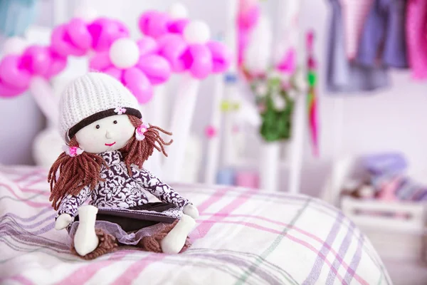 Cute doll on bed