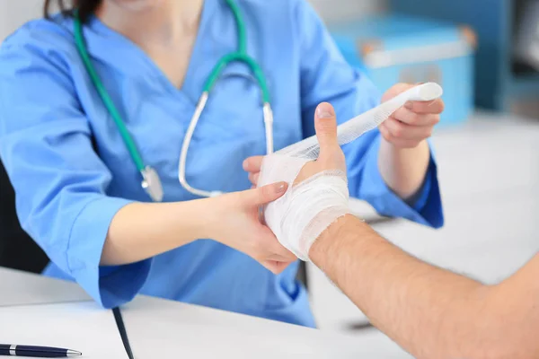 Médecin appliquant le bandage sur le patient — Photo