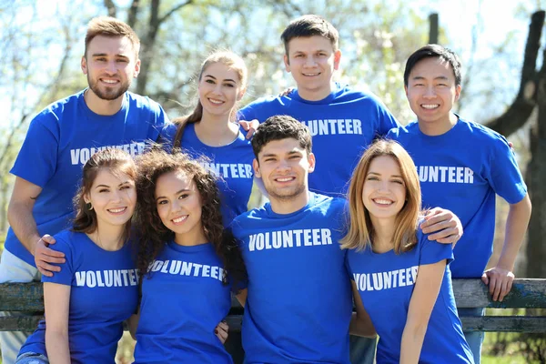 Group of volunteers in park on sunny day