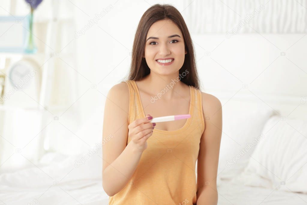 woman holding pregnancy test 
