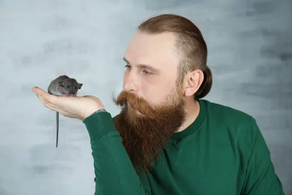 Bärtiger Mann mit lustiger Ratte auf farbigem Hintergrund — Stockfoto