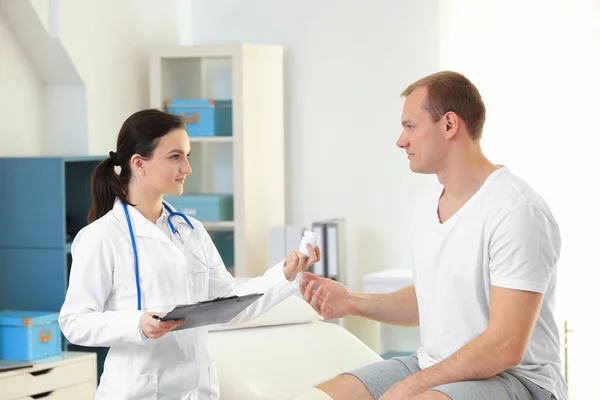 Ortopedista que da medicina al paciente en la clínica — Foto de Stock